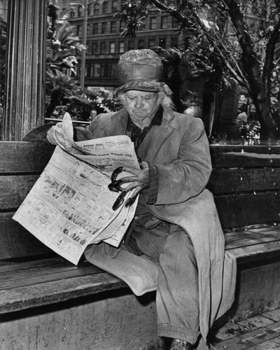 Reading a newspaper in Pershing Square