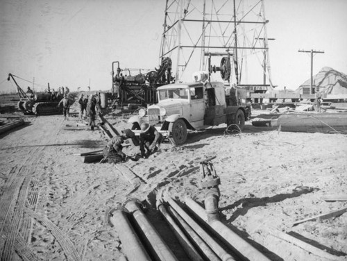 Laying pipe by an oil rig