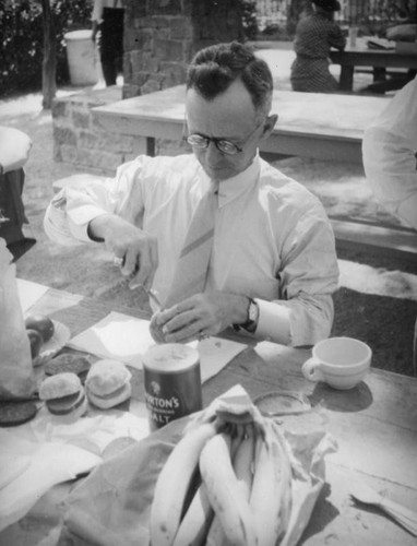 Cutting a bun at a picnic