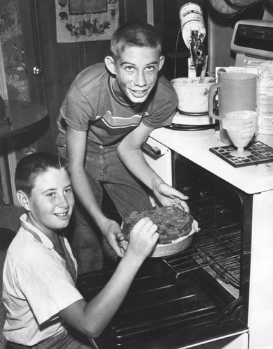 David Walser and Rickey Andrew baking a cake