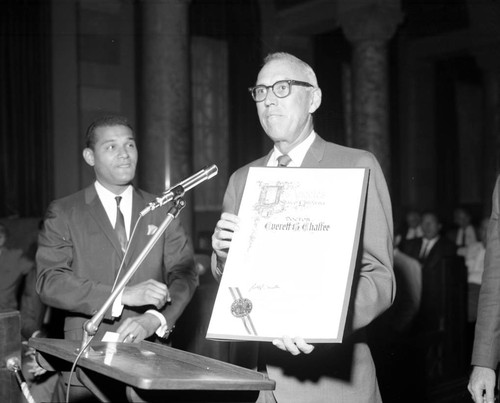 Billy Mills present resolution to Dr. Everett B. Chaffee