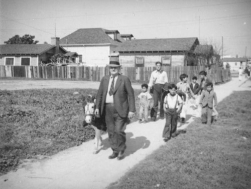 Men, children and a donkey in Boyle Heights