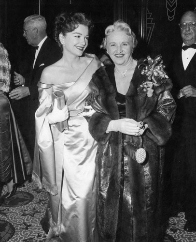 Anne Baxter and Julia Faye attend DeMille premiere