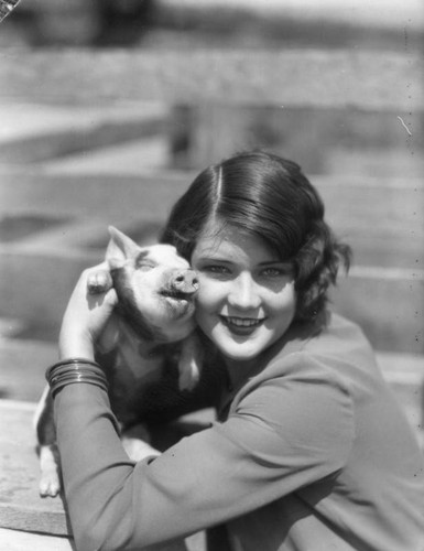 Woman holding baby pig