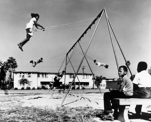 Children play in housing project playground