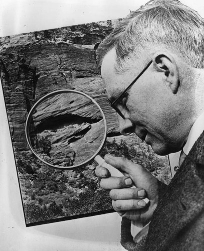 Man examining rock photo