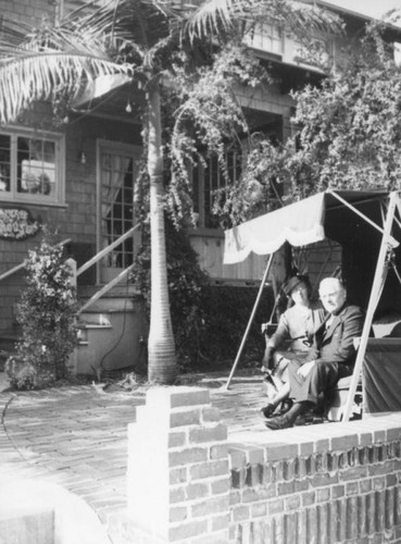 Ethel Schultheis' parents on a swing at the Ivar House