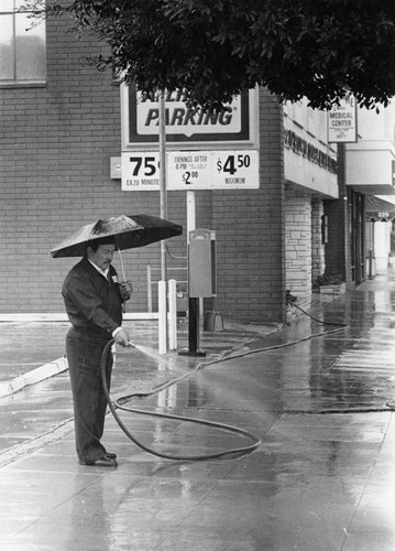 Washing down the sidewalk