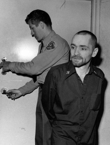 Charles Manson adds swastikas to his dress