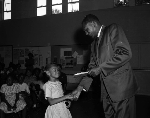 Councilman Tom Bradley presents reading award to students