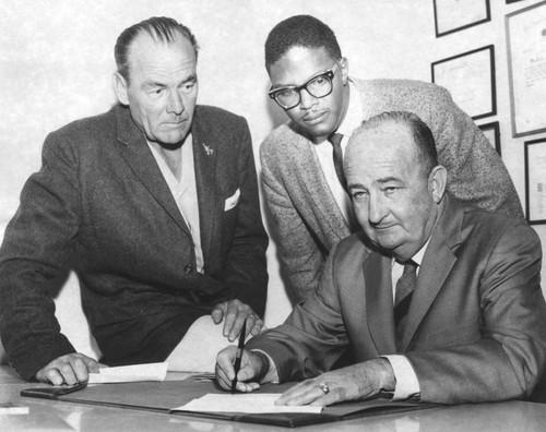 W. H. Coffin signs NAACP proclamation with Earl Erne and John J. Mance