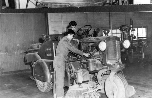 Sherman Indian High School students work on street sweeper