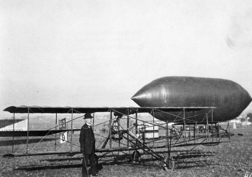 Dirigible and biplane on ground