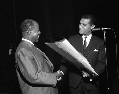 Louis Armstrong is presented with a resolution