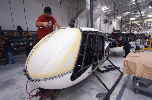 Installing helicopter windshields on the assembly line — Calisphere