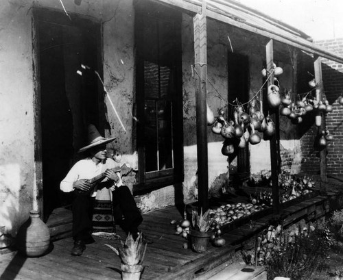 Musician at back "corredor" of Avila Adobe