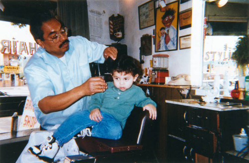 Grandfather gives grandson a trim