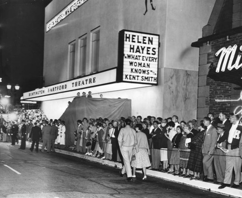 Crowd lines street outside theater