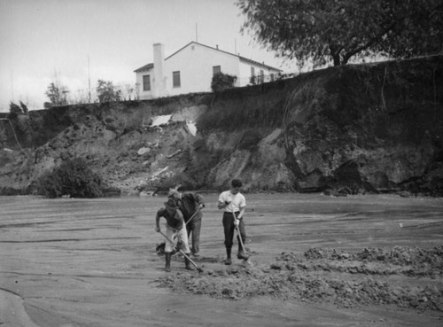 L.A. River flooding, digging in the riverbed in North Hollywood