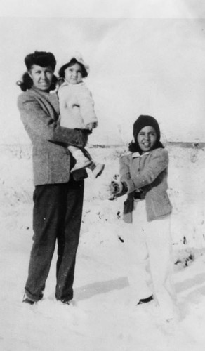 Mexican American woman and children in snow