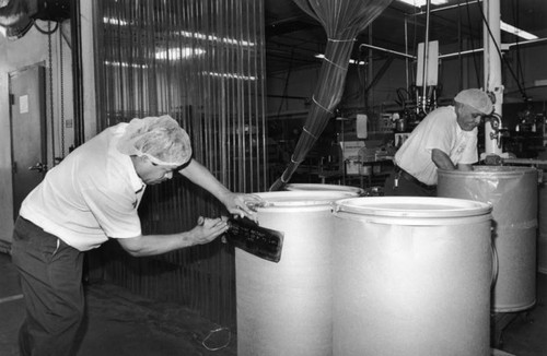 Filling mustard barrels, Walker Foods, Inc