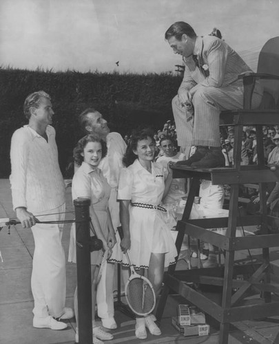 Douglas Fairbanks Jr. talks with tennis players