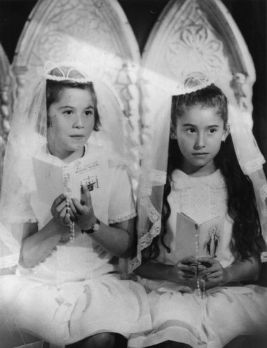 Portrait of Mexican American girls dressed for First Communion