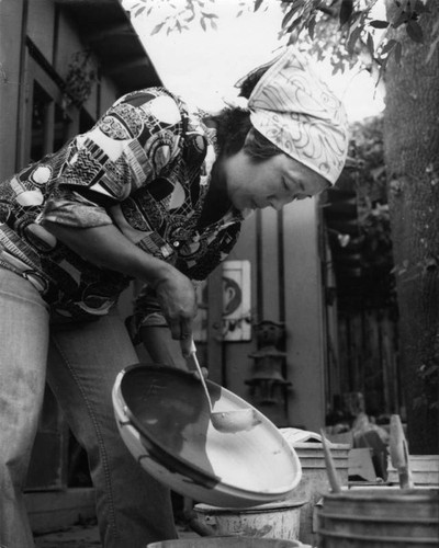 Mabel Enkoji glazes a bowl