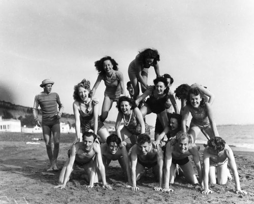 Group of acrobats on the beach, view 5