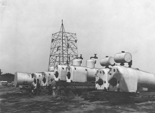 Crews rush work on a steel derrick