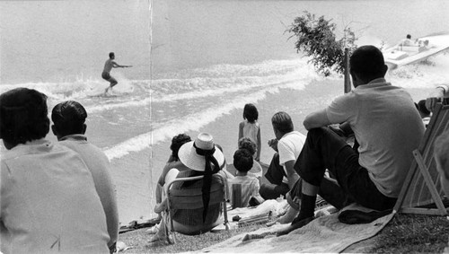 Spectators watch water skiing contest