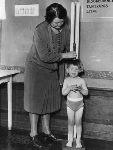 Child is measured for height