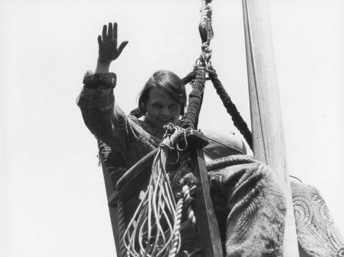 Woman on flagpole