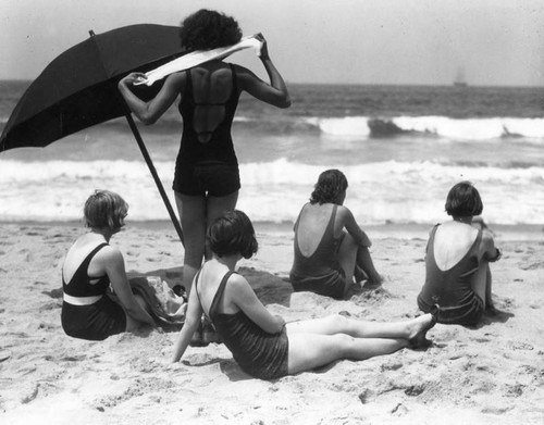 Women sitting on sand