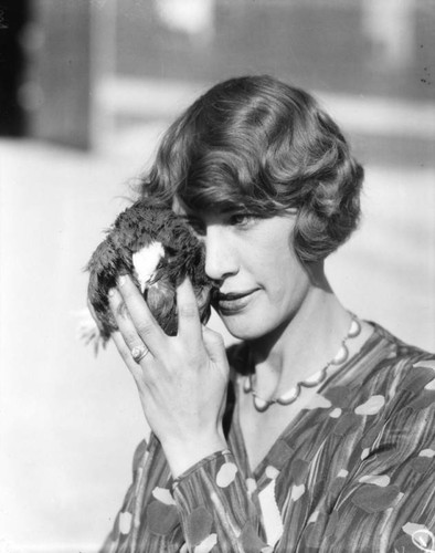 Woman seeing eye to eye with a bird