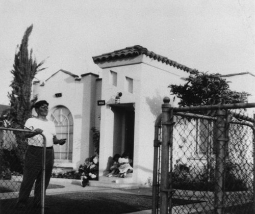 Mexican American man in front of home