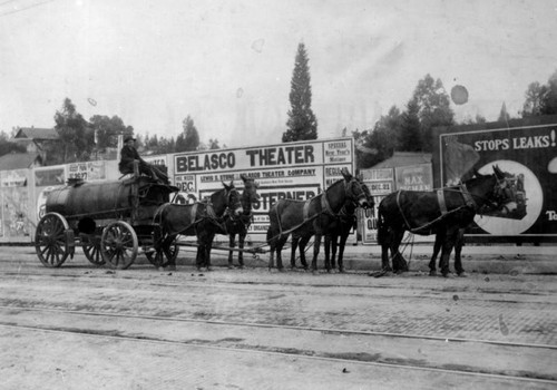 Mules hauling oil by wagon