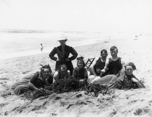 Family sitting next to algae at the beach