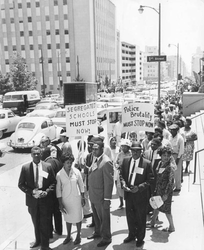 Demonstrators pause before courthouse in two-mile march