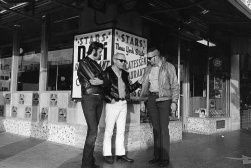 Three men talk on Hollywood Boulevard