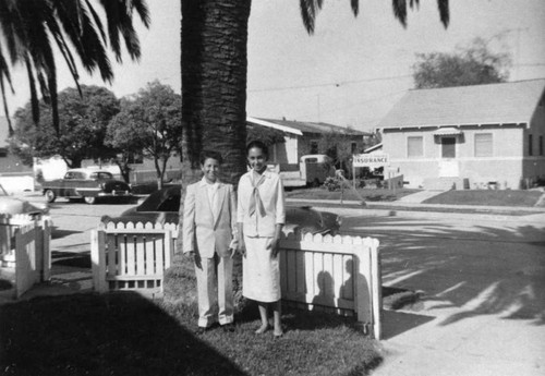 Mexican American boy and girl in front yard