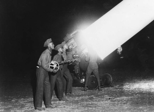 Men operating searchlight