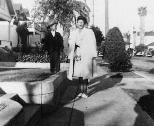 Audrey Lee and nephew on sidewalk