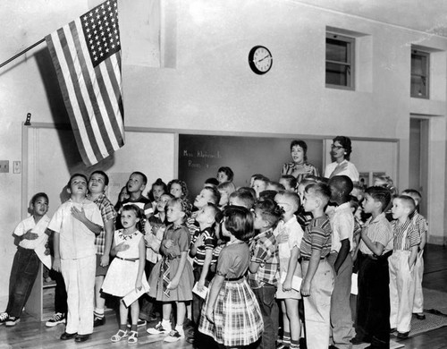 Two classes join in salute to the Flag