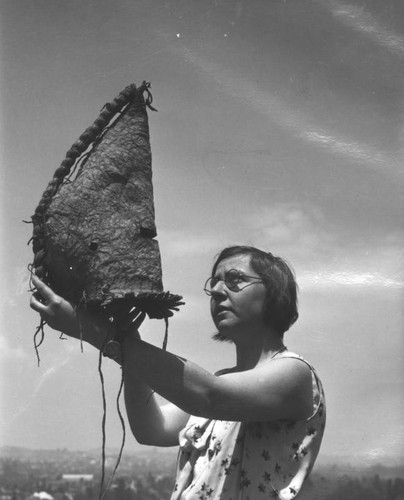 Holding a Native American mask