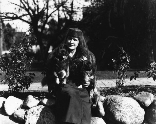 Woman and her two pekingese dogs