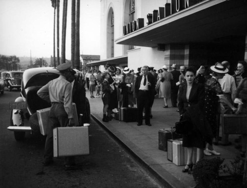 Passengers wait at Union Station entrance