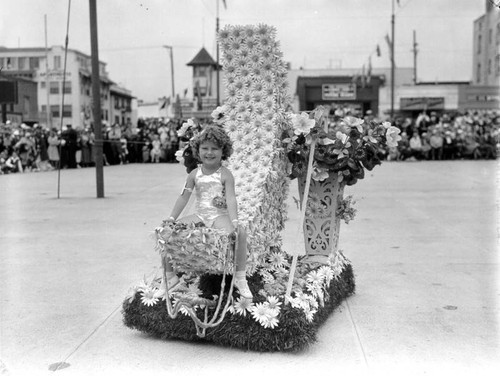 Girl on a floral parade float