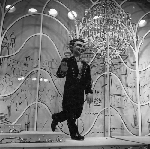 Liberace, show-girl puppets featured