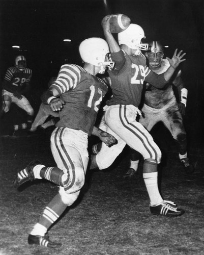 Van Nuys backfield ace Jerry Anding (29) set to fire an aerial